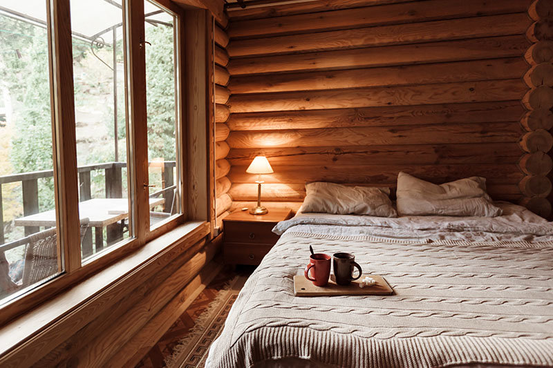 log cabin interior bedroom with breakfast tray